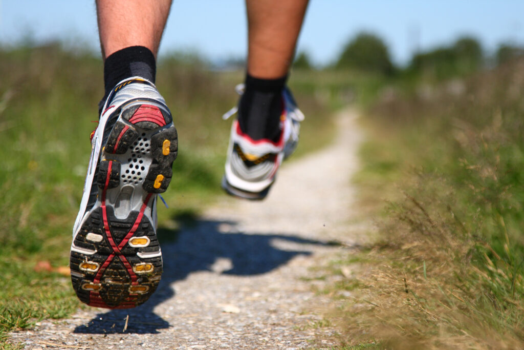 Person running along a track in running shoes. A lot of people are afraid of recreational running, as they believe it can lead to Osteoarthritis. Is that a myth or fact?