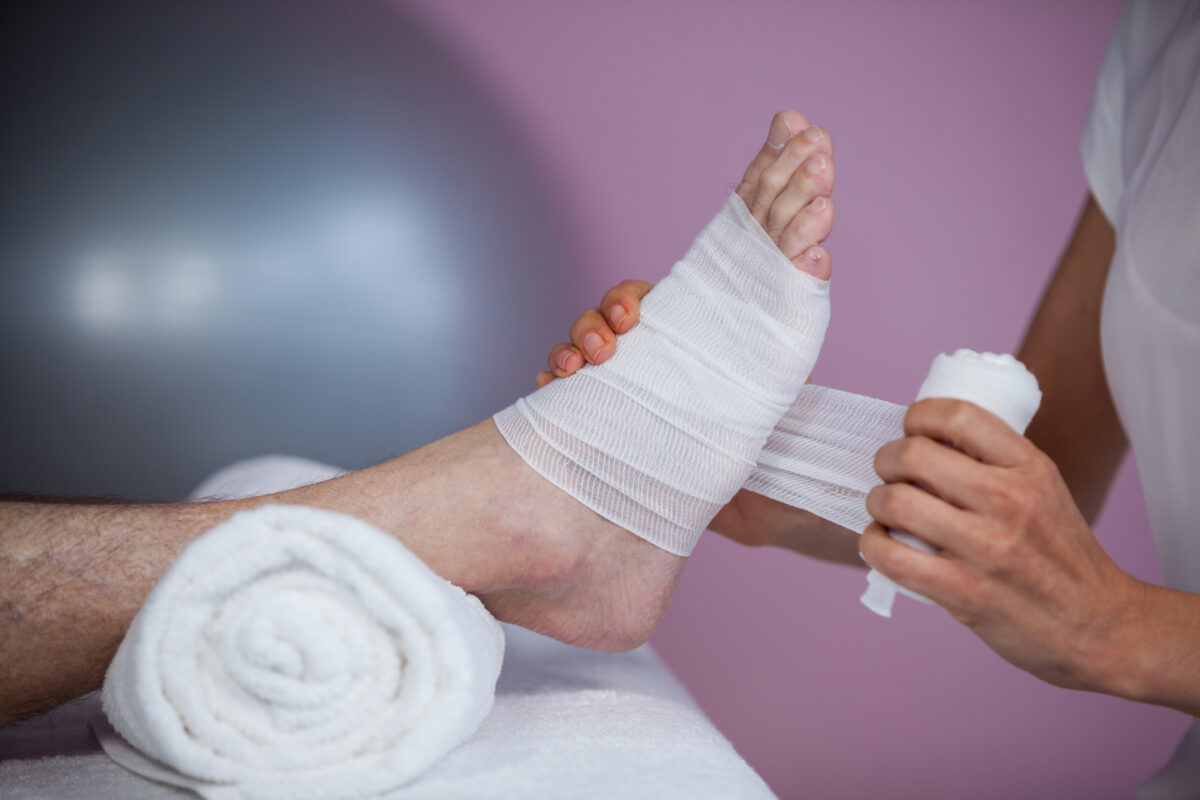 "PEACE and LOVE" is a principle for handling acute injuries. Pictured here is a therapist putting compress bandage on a foot